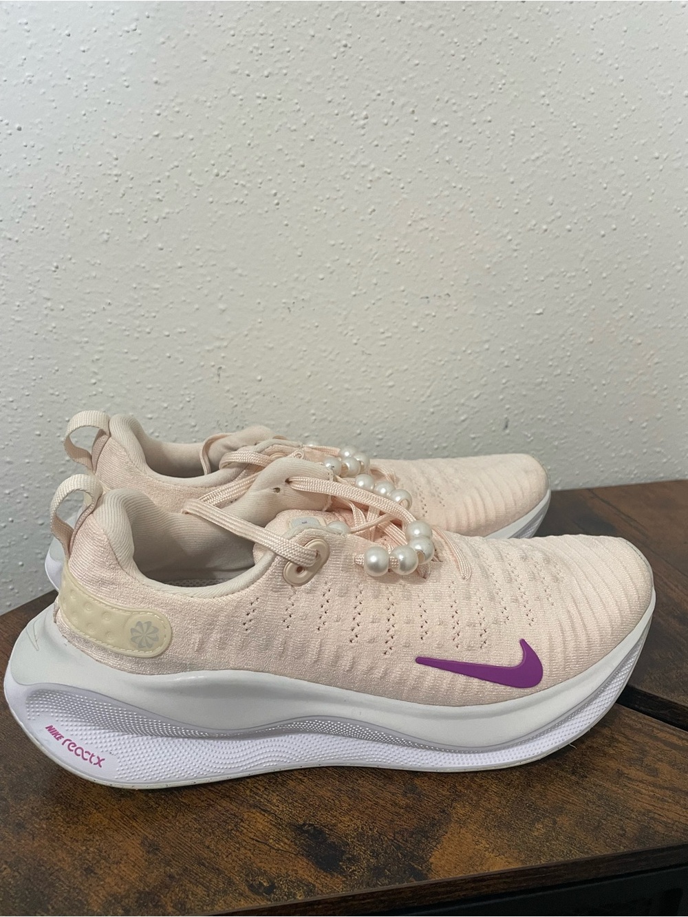 Nike Women’s Light Pink Sneakers with Purple Swoosh
